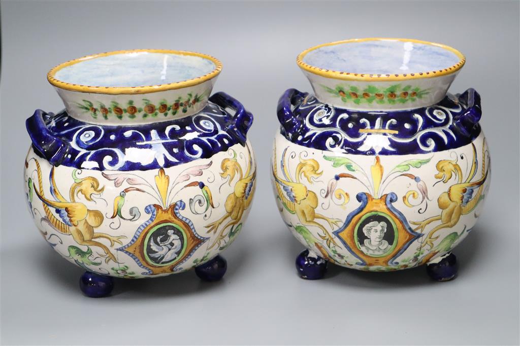A pair of Urbino style Delft bulbous-bodied two-handled vases, each on three feet, height 18cm